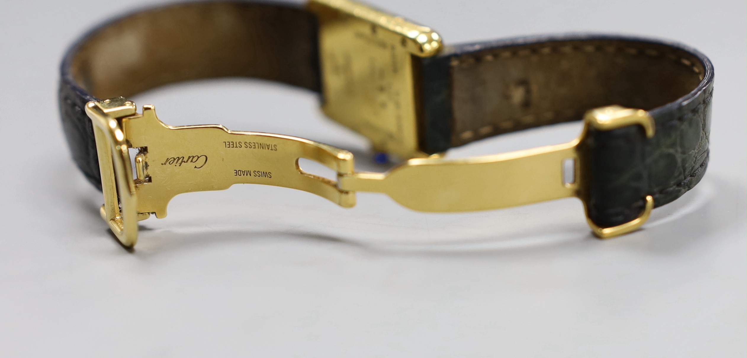 A lady's Must de Cartier silver gilt wristwatch, with quartz movement and blue cabochon winder